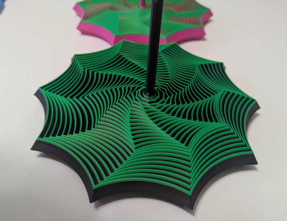 Fidget de Giro Estelar, pieza circular verde con diseño en espiral